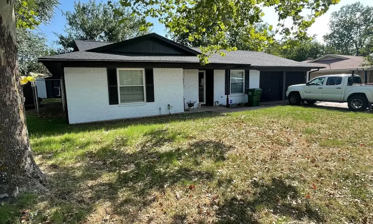 Professional roofing crew working on a residential roof in Pitman